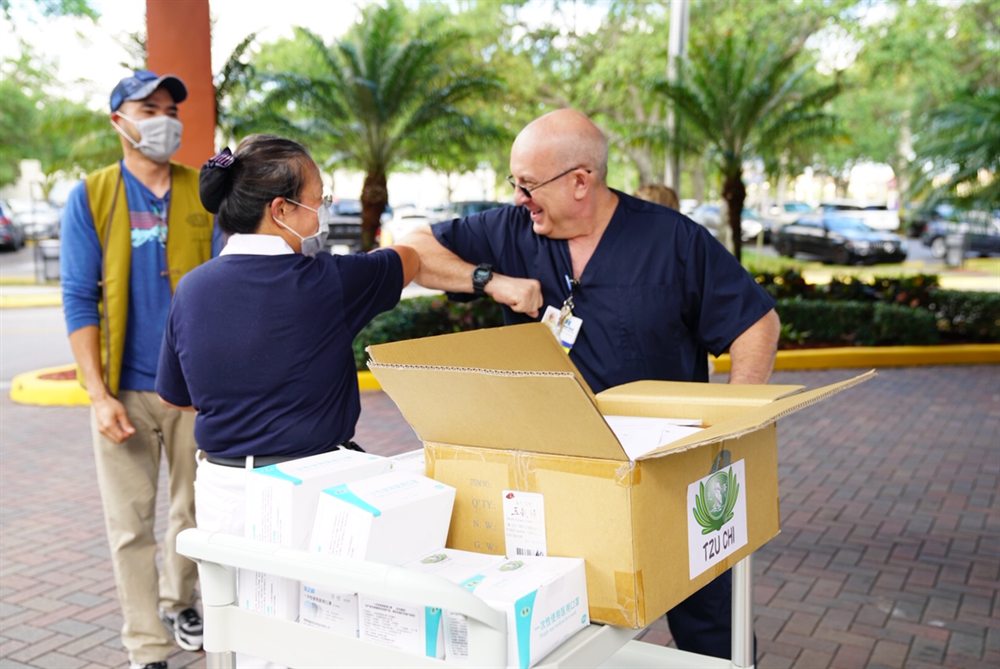 Volunteers delivering boxed protective supplies at a South Florida hospital